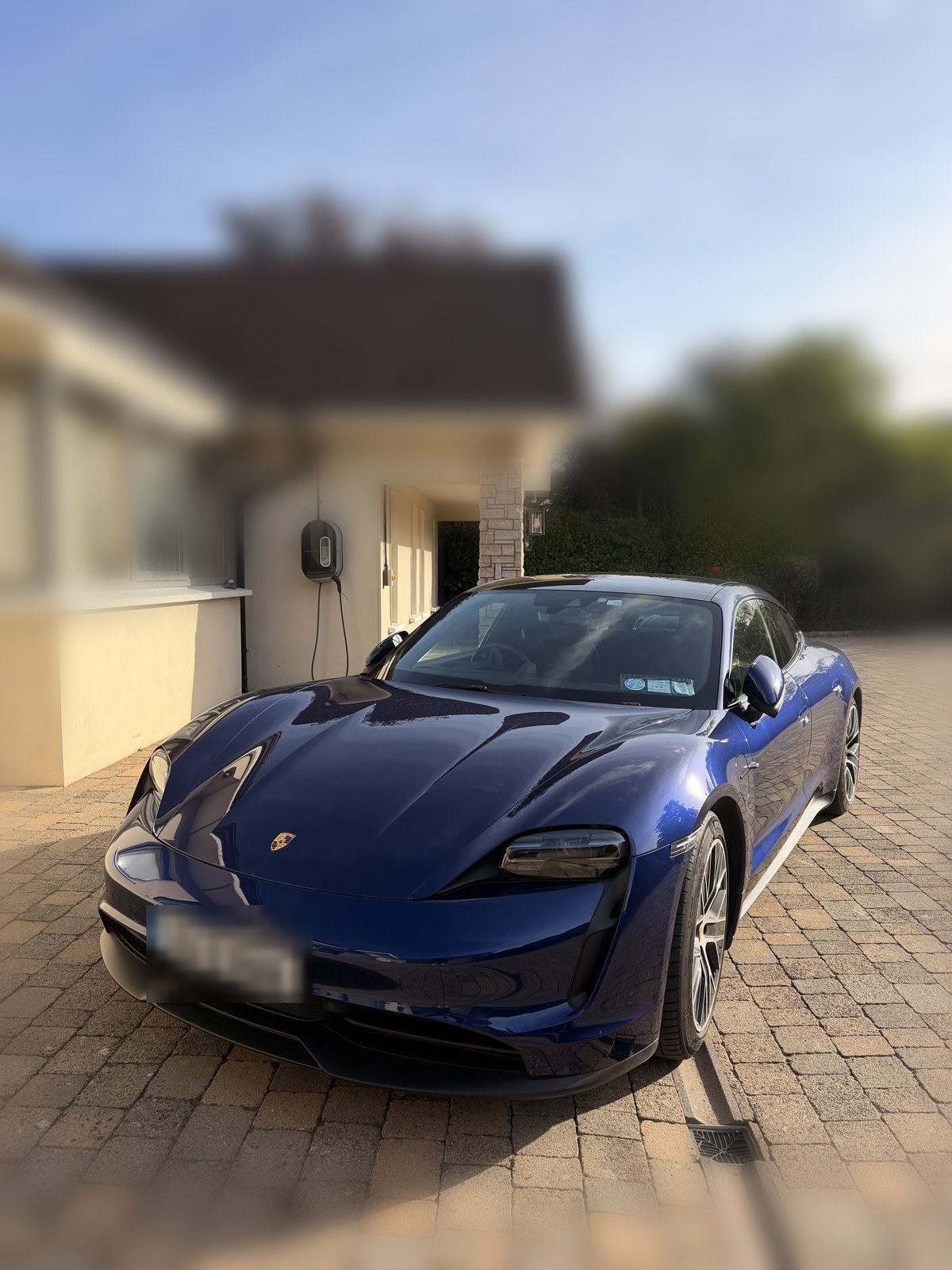The real Porsche Taycan the ad was generated from, parked on a driveway in Dublin